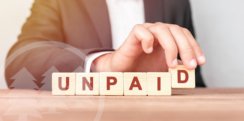 Man made word UNPAID with wood blocks | what happens if you don't pay hoa fees