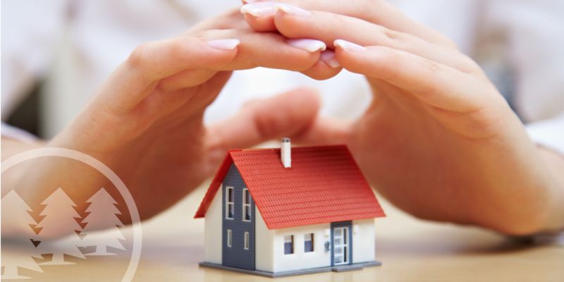 stencil (40) woman covering house model with hands | hoa insurance policy