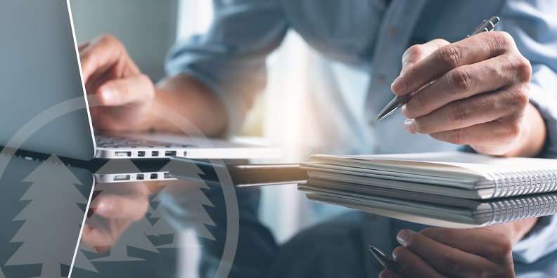 man writing on notebook and working on laptop | resources for HOA board