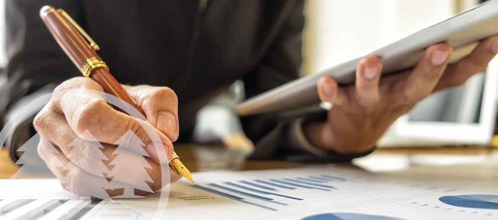woman holding pen and tablet analyzing graph woman holding pen and tablet analyzing graph | managing hoa reserve funds