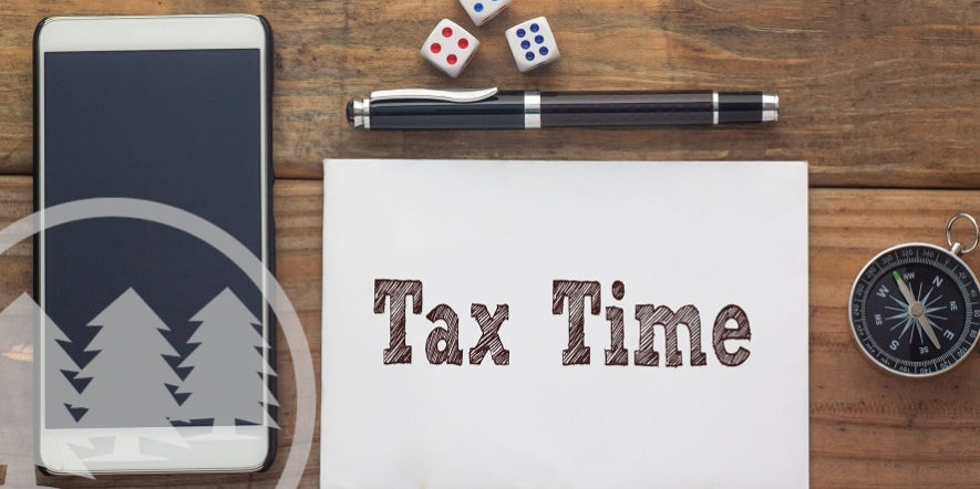 Tax Time written on white paper with dice, compass, smart phone and pen | hoa tax returns