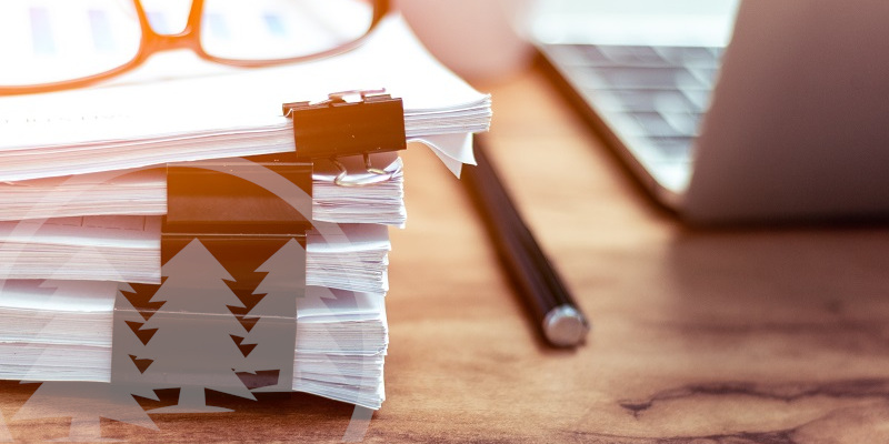 Stack of documents placed on a desk | choose your HOA registered agent