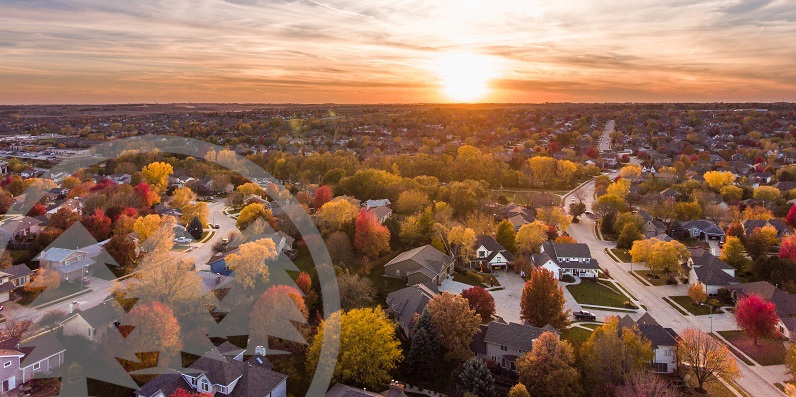 Sunset in the fall over the suburban neighborhood | prepare HOA community for fall