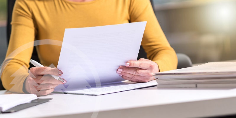 woman checking documents woman checking documents | hoa governing documents