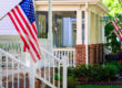 A line of suburban homes display large American Flags | hoa flag rules