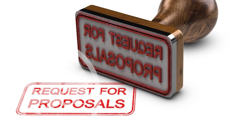 Request for proposals printed on a white background with rubber stamp | association management RFP
