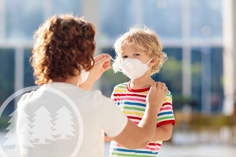 Woman protecting her child by using a face mask | hoa board members and covid-19